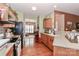 Open kitchen featuring wood cabinets and countertop space that seamlessly flow into the dining at 128 S Arcadian Way, Mooresville, NC 28117