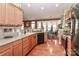 Well-lit kitchen featuring stainless steel appliances, wood cabinets, and hardwood flooring at 128 S Arcadian Way, Mooresville, NC 28117