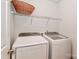 A dedicated laundry area featuring a washer and dryer set and above-appliance shelving at 128 S Arcadian Way, Mooresville, NC 28117