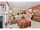 Living room with a cozy sofa and ottoman open to the breakfast bar and kitchen at 128 S Arcadian Way, Mooresville, NC 28117