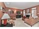 Cozy living room with a fireplace, comfortable seating, and a mounted television at 128 S Arcadian Way, Mooresville, NC 28117