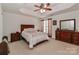 Cozy bedroom featuring tray ceilings, a ceiling fan and neutral color palette at 128 S Arcadian Way, Mooresville, NC 28117