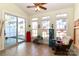 Bright sunroom featuring a ceiling fan, tile flooring, and large sliding glass doors at 128 S Arcadian Way, Mooresville, NC 28117