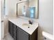 Modern bathroom with a large mirror, sleek vanity, and neutral tones at 13811 Waverton Ln, Huntersville, NC 28078