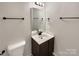 Bathroom featuring a sink, vanity, mirror, lighting, towel racks, and toilet at 13811 Waverton Ln, Huntersville, NC 28078