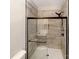 Bathroom featuring a glass enclosed shower with updated tile and matte black hardware at 13811 Waverton Ln, Huntersville, NC 28078