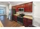 Well-equipped kitchen with stainless steel appliances and cherry wood cabinets at 13811 Waverton Ln, Huntersville, NC 28078