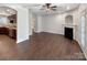 Open concept living room featuring hardwood floors, fireplace, and access to kitchen at 13811 Waverton Ln, Huntersville, NC 28078