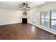 Spacious living room with a fireplace, hardwood floors, and a ceiling fan at 13811 Waverton Ln, Huntersville, NC 28078