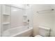 Clean bathroom featuring a tub-shower combo with built-in shelving and a white toilet at 146 Prestwick Way # 20, Mooresville, NC 28115