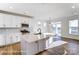 Modern kitchen featuring white cabinets, stainless steel appliances, an island, and hardwood floors at 146 Prestwick Way # 20, Mooresville, NC 28115