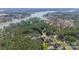 An aerial view of the property located near a lake, featuring mature trees and well-maintained grounds at 165 Blue Ridge Trl, Mooresville, NC 28117