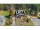 An aerial view of a two-story home with a gray roof, a well-manicured lawn, and mature trees surrounding the property at 165 Blue Ridge Trl, Mooresville, NC 28117