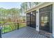 Relaxing screened back porch with wooden floors and wooded view at 165 Blue Ridge Trl, Mooresville, NC 28117