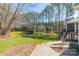 Large backyard with lush lawn, mature trees, and storage shed providing ample space for outdoor activities and relaxation at 165 Blue Ridge Trl, Mooresville, NC 28117