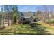 Image of the house's backyard with a patio, green grass, and trees, offering a serene outdoor space at 165 Blue Ridge Trl, Mooresville, NC 28117