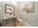 Modern bathroom with stone accent wall, vessel sink, and decorative art at 165 Blue Ridge Trl, Mooresville, NC 28117
