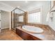 Bright bathroom featuring a soaking tub, a separate shower, and a window at 165 Blue Ridge Trl, Mooresville, NC 28117