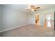 Spacious bedroom with neutral carpet, ceiling fan, and doorway to adjoining bathroom at 165 Blue Ridge Trl, Mooresville, NC 28117