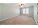Cozy bedroom featuring neutral walls, plush carpeting, and a window offering ample natural light at 165 Blue Ridge Trl, Mooresville, NC 28117