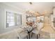 Bright dining area featuring natural light, modern chandelier, and stylish table setting and white kitchen at 165 Blue Ridge Trl, Mooresville, NC 28117