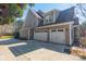 Exterior view of home featuring three-car garage, driveway, and neutral siding at 165 Blue Ridge Trl, Mooresville, NC 28117