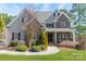 Charming home with stone and siding exterior, landscaped front yard, and inviting front porch at 165 Blue Ridge Trl, Mooresville, NC 28117