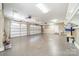 Spacious three car garage featuring epoxy flooring and painted white doors at 165 Blue Ridge Trl, Mooresville, NC 28117
