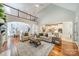 Open-concept living space with hardwood floors, neutral decor, and a view of the kitchen and dining areas at 165 Blue Ridge Trl, Mooresville, NC 28117