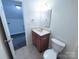 Bathroom featuring a toilet, vanity with a sink and a doorway to another room at 1806 Bringle Ferry Rd, Salisbury, NC 28146