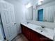Well-lit bathroom with double sinks and wooden vanity cabinets, providing ample space and storage at 1806 Bringle Ferry Rd, Salisbury, NC 28146
