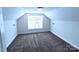 Bedroom with neutral carpet and walls, and a large window to bring in natural light at 1806 Bringle Ferry Rd, Salisbury, NC 28146