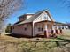 View of the exterior showcasing the inviting covered porch and manicured lawn at 1806 Bringle Ferry Rd, Salisbury, NC 28146