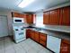 Functional kitchen features white appliances, wood cabinets, and durable countertops at 1806 Bringle Ferry Rd, Salisbury, NC 28146