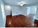 Living room with hardwood floors, ceiling fan, and access to other rooms of the house at 1806 Bringle Ferry Rd, Salisbury, NC 28146