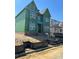 Under construction home featuring large windows, green sheathing and brick foundation on a sunny day at 19032 Newburg Hill Rd, Davidson, NC 28036
