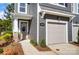 Beautiful townhome front exterior featuring a garage door and a modern door with glass paneling at 2310 Hedgecliff Rd # 159, Kannapolis, NC 28025