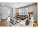 Well-lit living room featuring a comfortable sofa, large windows, and neutral decor at 2310 Hedgecliff Rd # 159, Kannapolis, NC 28025
