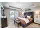 Comfortable bedroom featuring tray ceilings, a plush bed, and ample natural light from two windows at 2310 Hedgecliff Rd # 159, Kannapolis, NC 28025
