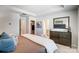 Well-lit bedroom features a dresser, and doorways to the ensuite bathroom and walk-in closet at 2310 Hedgecliff Rd # 159, Kannapolis, NC 28025