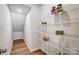 Walk-in pantry features bright lighting, wooden floor and white shelving for optimal storage solutions at 2310 Hedgecliff Rd # 159, Kannapolis, NC 28025