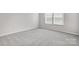 Well-lit bedroom with neutral walls, carpet flooring, and bright double windows at 2320 Hedgecliff Rd # 158, Kannapolis, NC 28025