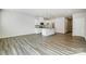 Open-concept layout with modern kitchen, granite island, stainless appliances, and hardwood flooring at 2320 Hedgecliff Rd # 158, Kannapolis, NC 28025
