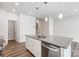 Close up of a spacious kitchen island with granite countertop, stainless steel dishwasher and pendant lights at 2320 Hedgecliff Rd # 158, Kannapolis, NC 28025