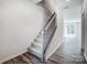 Carpeted staircase with wood and iron railing connecting multiple floors and hardwood floor entryway at 2320 Hedgecliff Rd # 158, Kannapolis, NC 28025