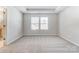 Light-filled bedroom featuring a tray ceiling and a connecting bathroom at 2330 Hedgecliff Rd # 157, Kannapolis, NC 28025