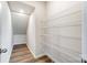 Walk-in closet with multiple shelves and wood floor at 2330 Hedgecliff Rd # 157, Kannapolis, NC 28025