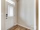 Bright entryway with wood-look flooring and white door with glass inserts at 2330 Hedgecliff Rd # 157, Kannapolis, NC 28025