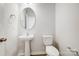 Clean half-bathroom features a pedestal sink, round mirror and modern fixtures at 2340 Hedgecliff Rd # 156, Kannapolis, NC 28025
