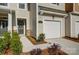 Close-up exterior view of a townhome featuring a one-car garage and covered entryway at 2340 Hedgecliff Rd # 156, Kannapolis, NC 28025